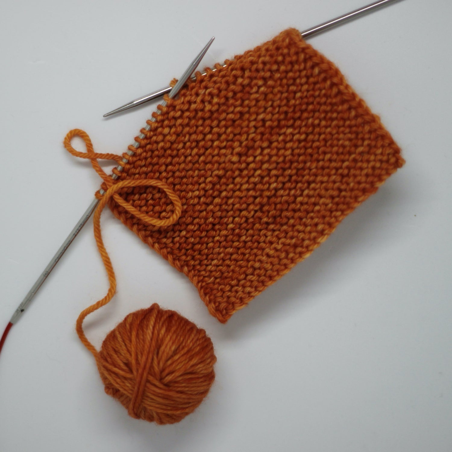 Knitting project Knitter's Kitchen orange yarn